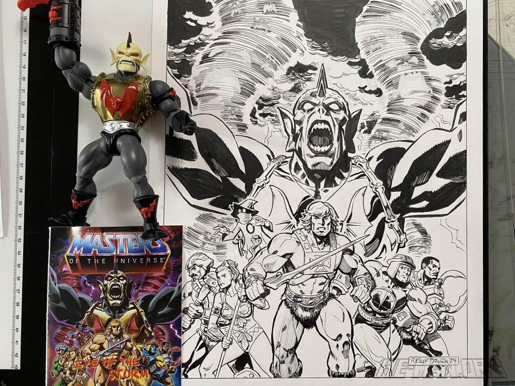 Photo by Reilly Brown. Of the inked cover for Masters of the Universe Origins mini-comic "Eye of the Storm", and next to it the final printed mini-comic. The toy figure for Hurricane Hordak also next to them.